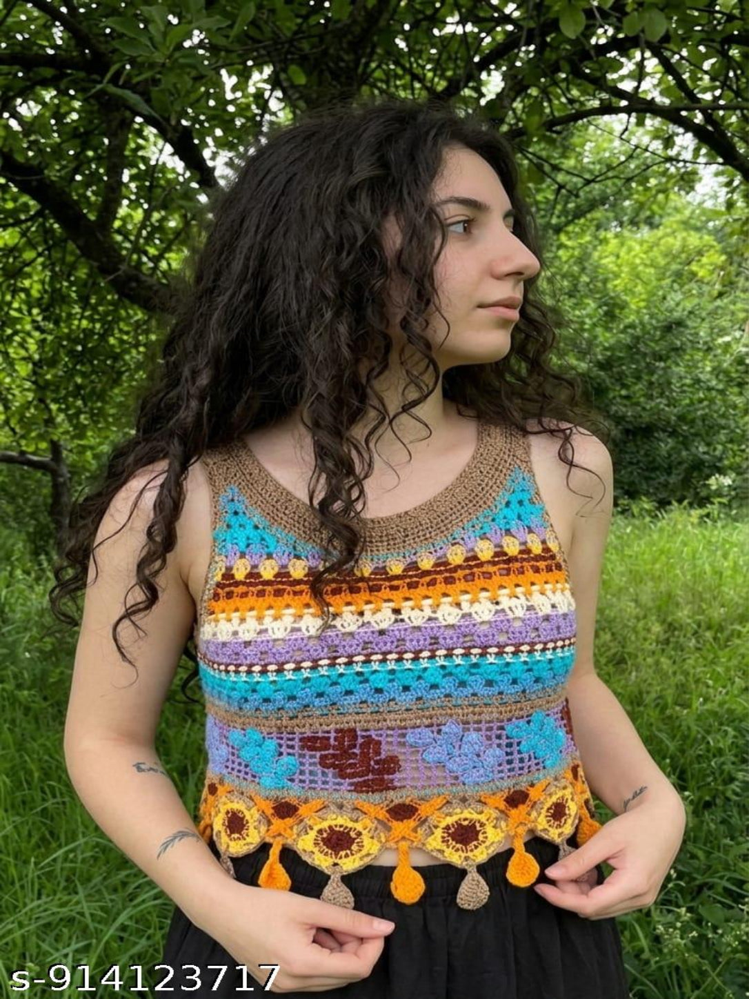 Woman wearing a colorful crochet top in a natural setting